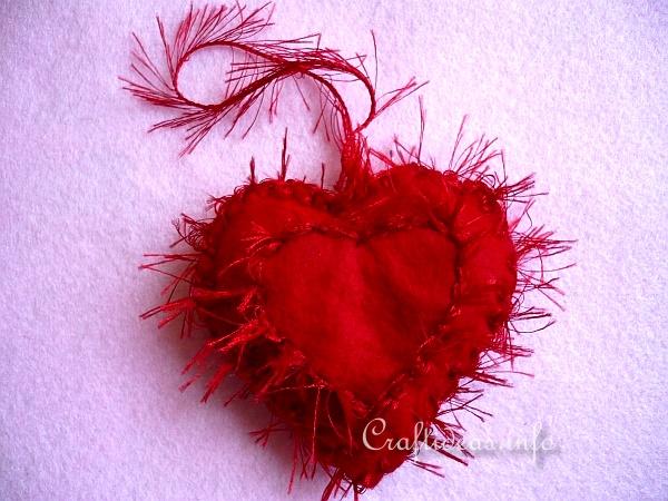 This heart is actually two felt hearts sewn together with fringe yarn 